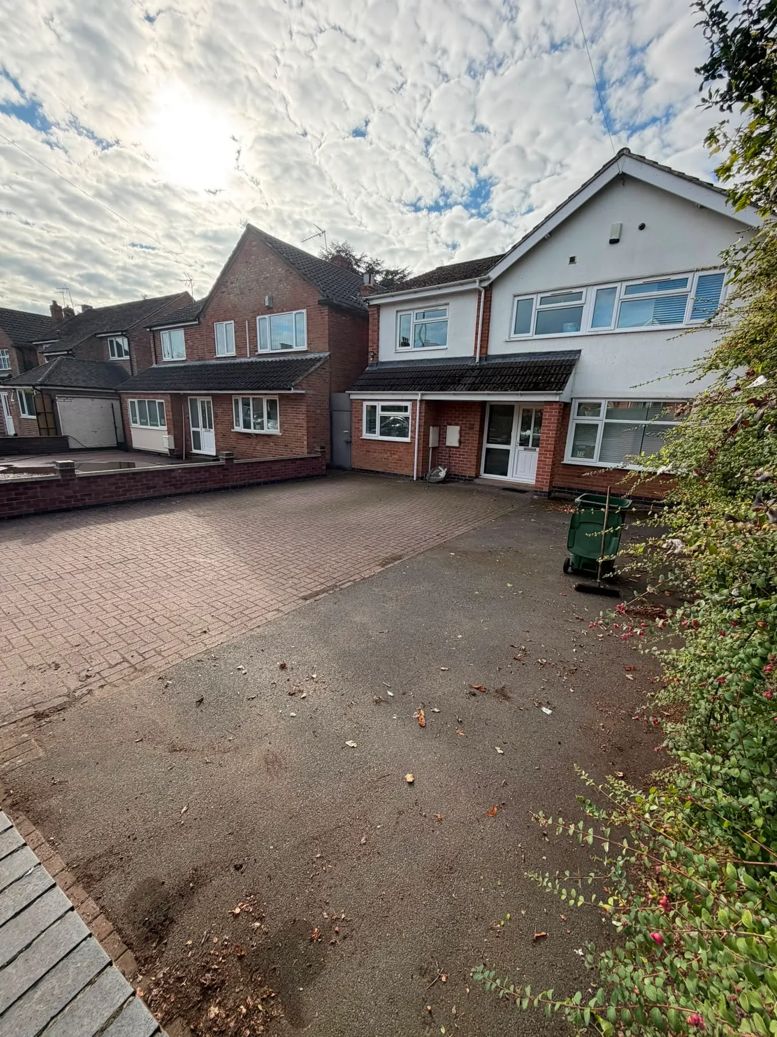 Tarmac driveway in Loughborough before cleaning by Midland Revive, dark with ingrained dirt.