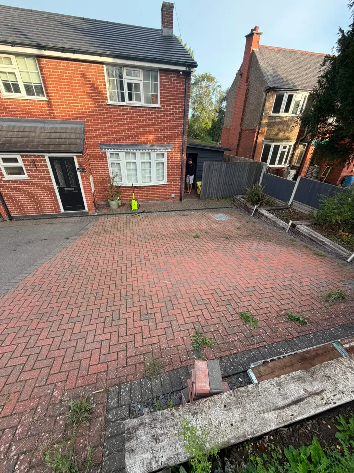 Block-paved driveway in Thringstone before cleaning by Midland Revive, with weeds and surface discolouration.